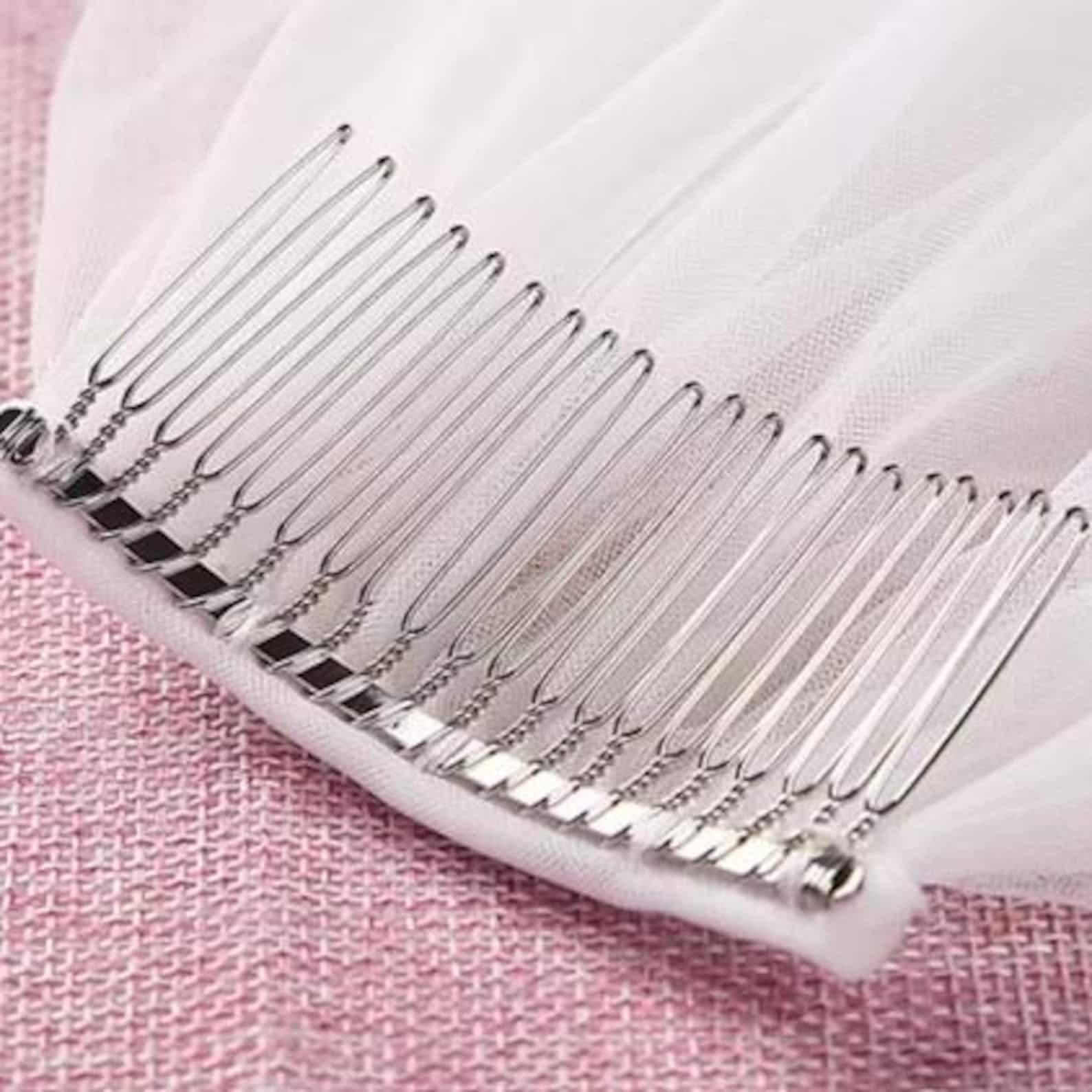 Detail of a silver veil comb on tulle